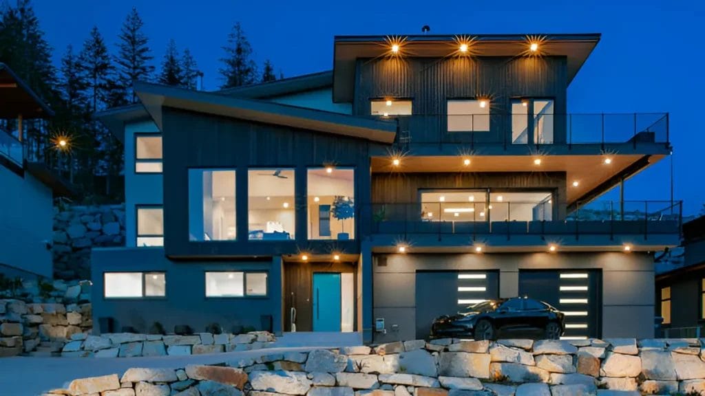 A photo of a modern mountain home with a rustic design. The home has a wooden exterior and is surrounded by trees